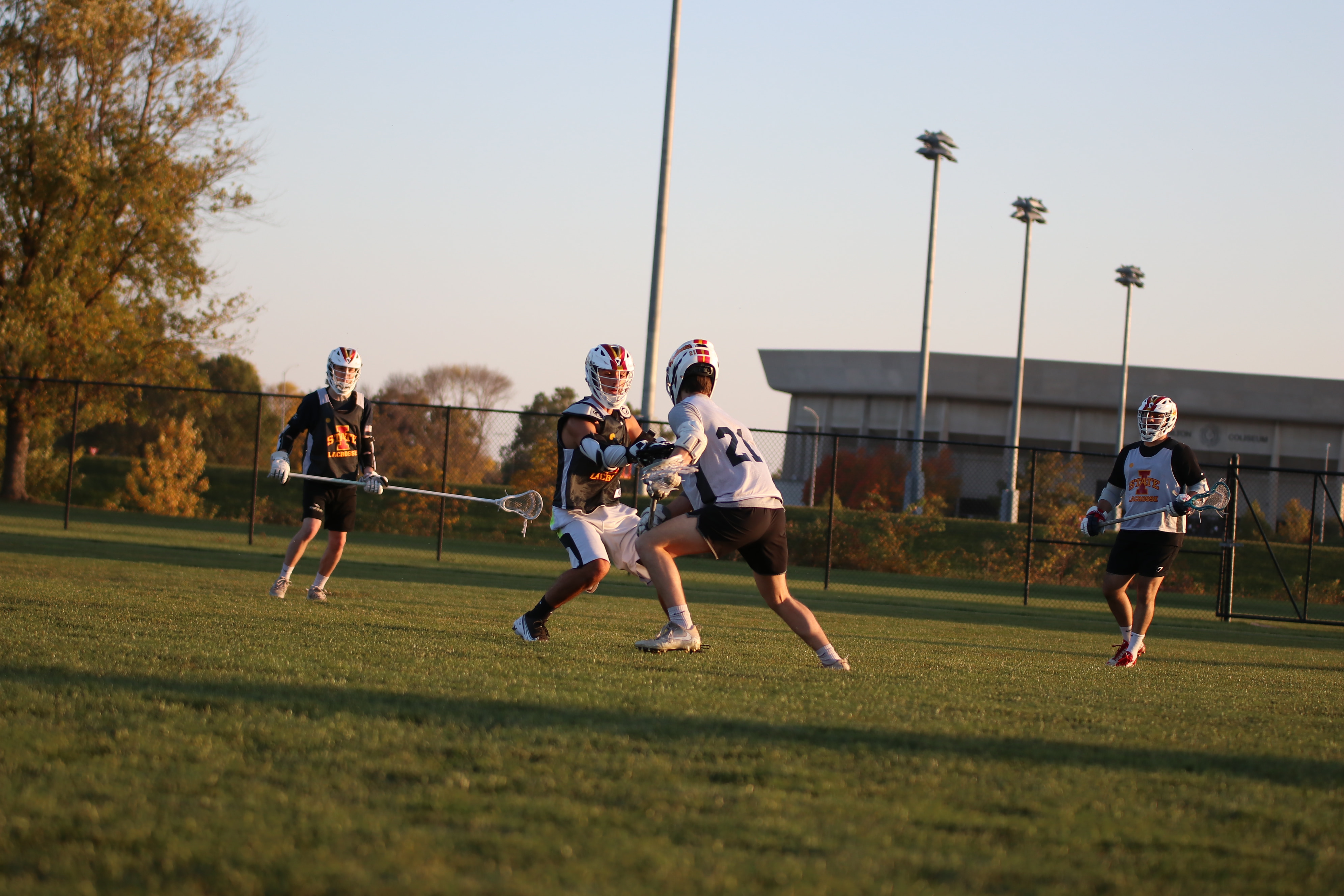 a photo of a group of people playing lacrosse on the lied rec field