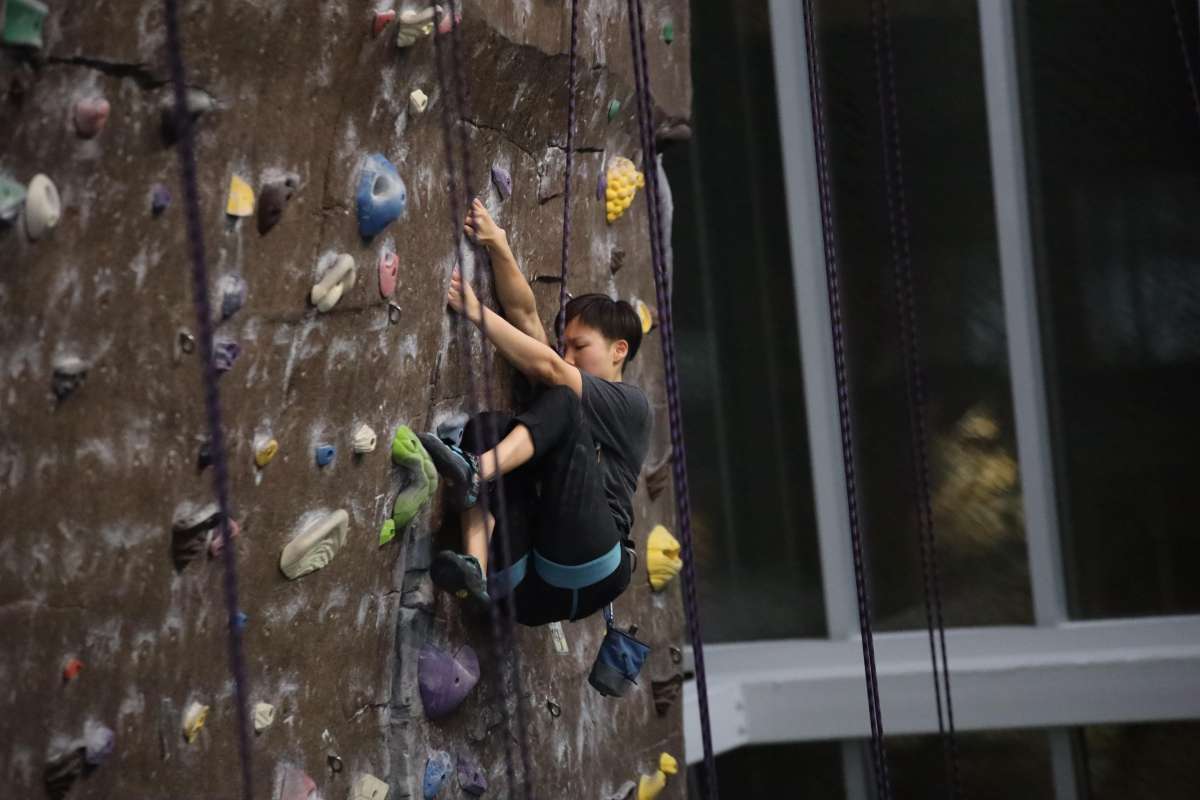 Person Climbing top rope wall.