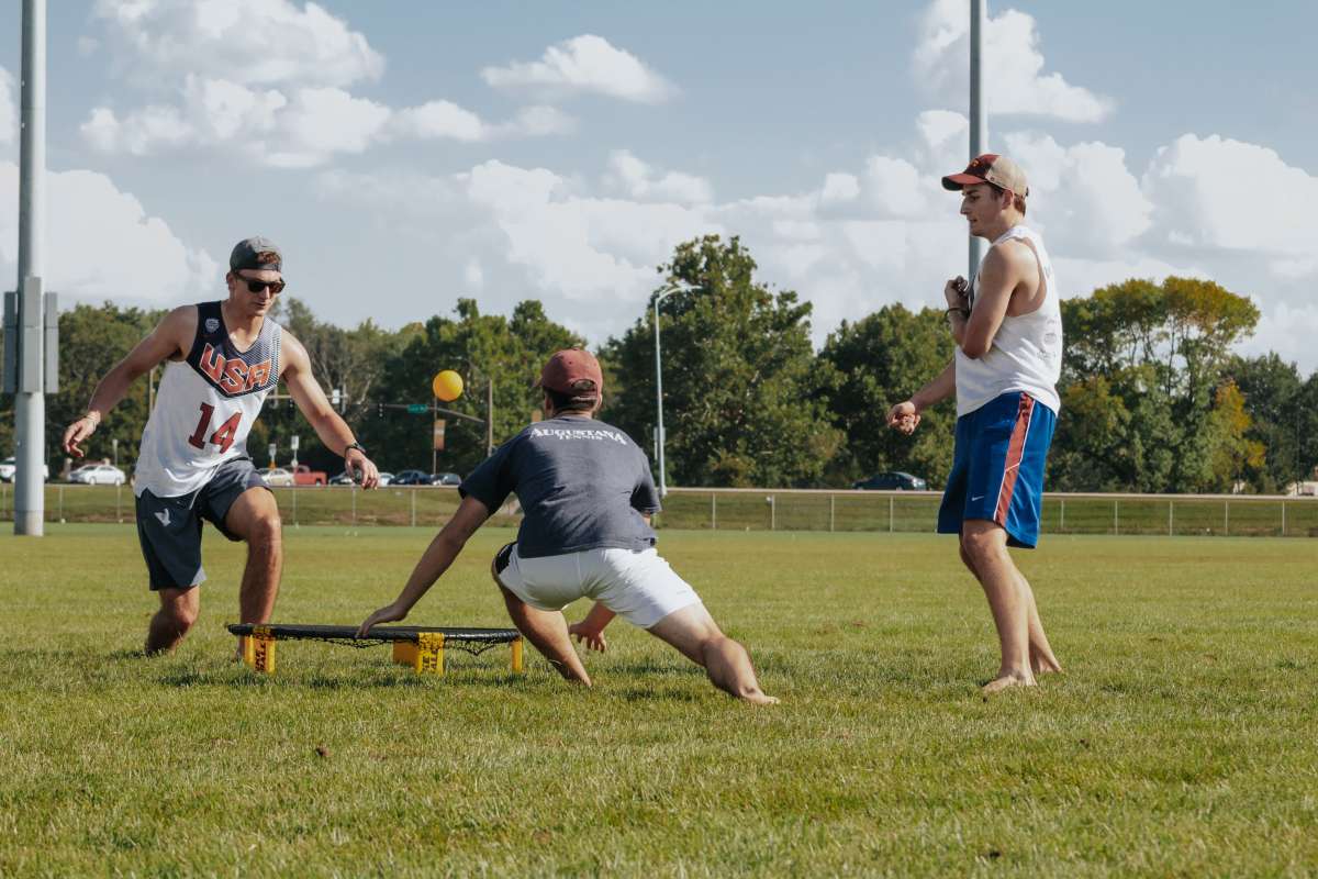 a photo of a team playing spikeball